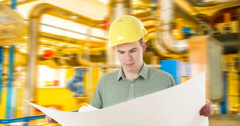 manufacturing worker looking at a plan