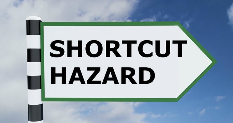 Sign saying "SHORTCUT HAZARD"